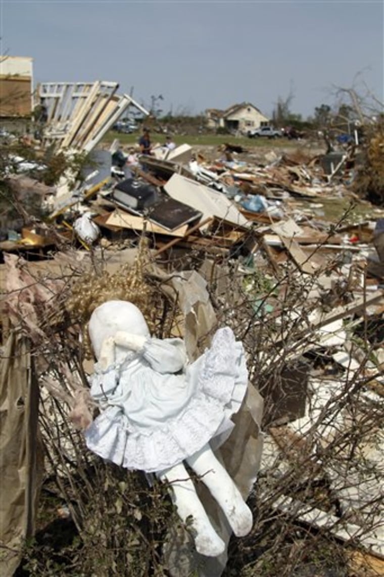 A doll hangs in a bush at a home in Colerain, N.C., on Monday after a tornado ripped through the area Saturday. 